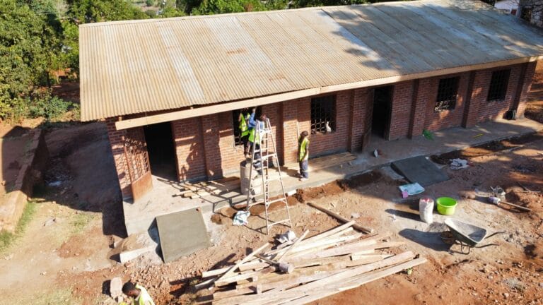 Construction site view of a new primary school building in rural Malawi.