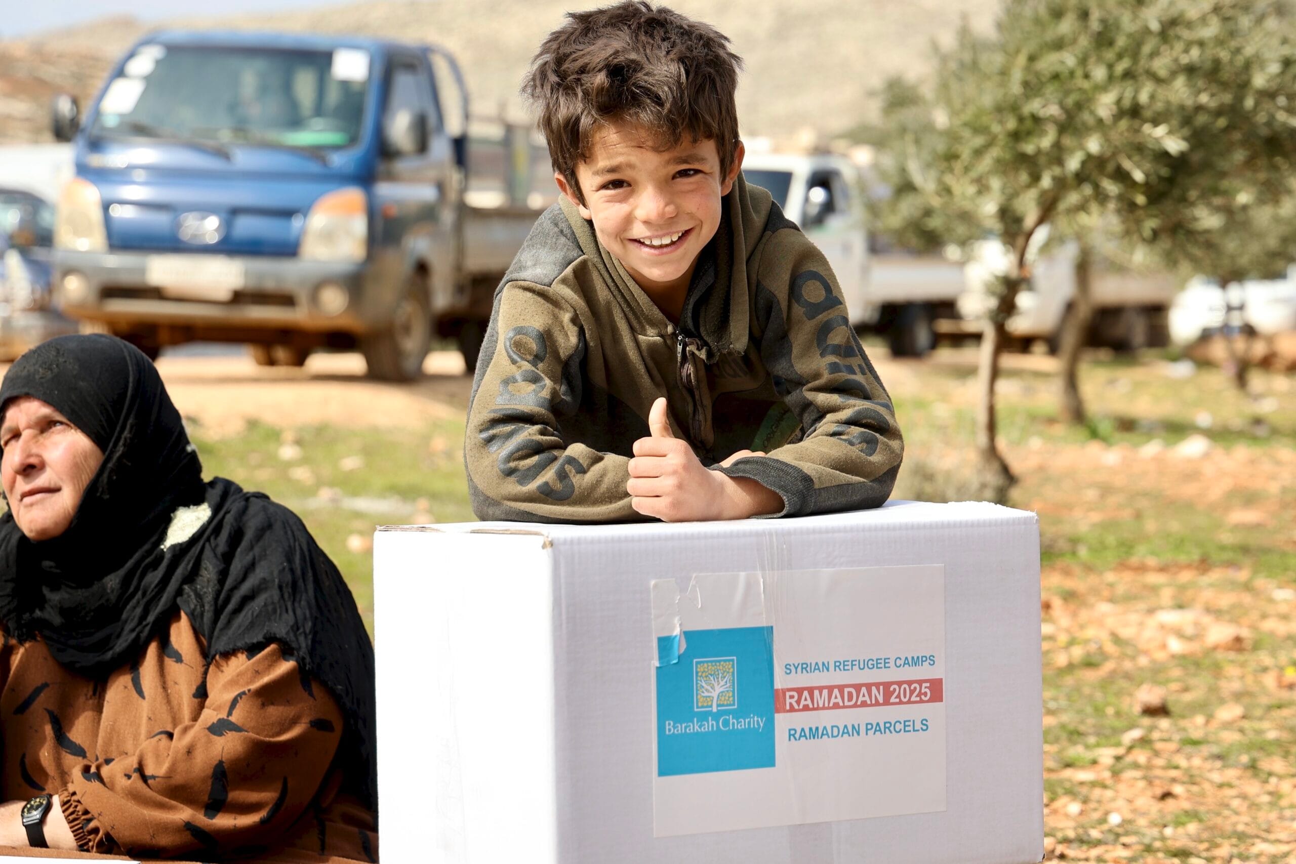 Young boy smiles with his ramadan food parcel