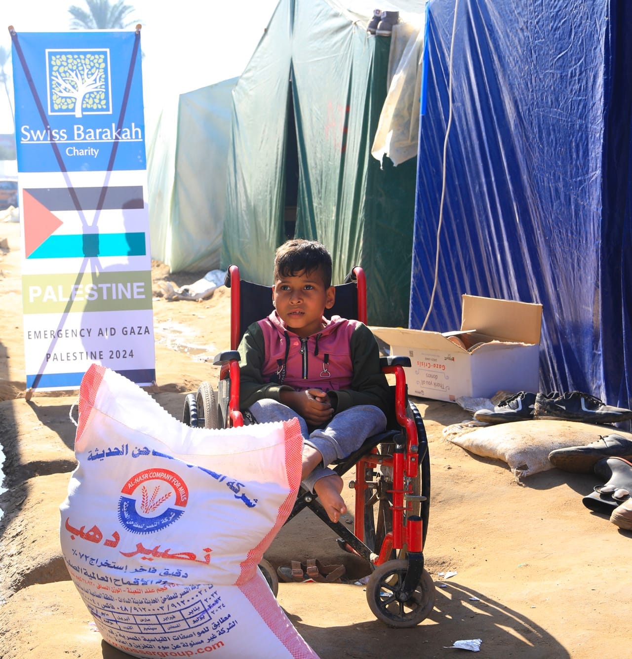 "Zakat al Fitre distribution to needy child in Gaza tent camp"